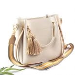A white purse with two tassels on the side.