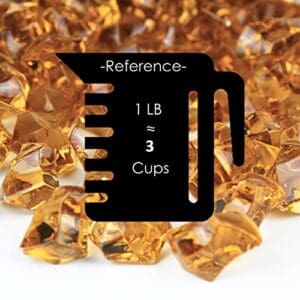 A cup of gold colored rocks with the words reference to it.