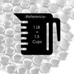 A black and white photo of a measuring cup