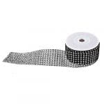 A roll of black and white ribbon with small dots.