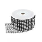 A roll of black and white ribbon with silver beads.