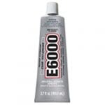 A tube of e 6 0 0 0 glue is sitting on the floor.