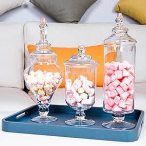 Three jars of candy are on a tray.