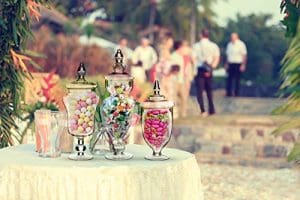 A table with three jars filled with candy.
