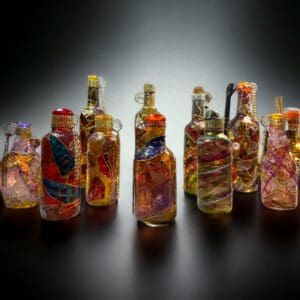 A group of glass bottles with different colored decorations.