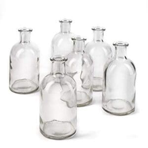 A group of six glass bottles with different shapes.
