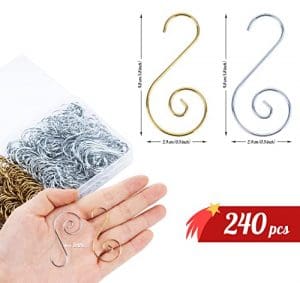 A hand holding some metal wire and other items