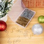 A wooden table with some ornaments and a box of metal wire.