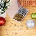 A wooden table with some ornaments and a box of metal wire.