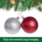 A red and silver ornament hanging from a christmas tree.