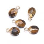 A group of six tiger eye stones sitting on top of each other.