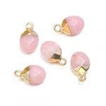 A group of pink and gold charms.