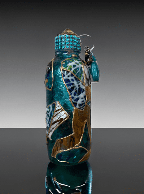 A bottle with a glass lid and a decorative pattern.