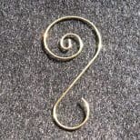 A metal spiral on the ground with some writing