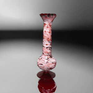 A red glass vase sitting on top of a table.