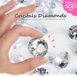 A hand holding onto a diamond with the words " crystals diamonds ".