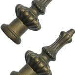 A pair of antique brass knobs with a crown design.