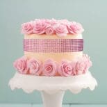 A cake with pink roses on top of it.