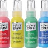 A group of four bottles with different colors.