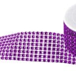 A purple roll of rhinestones on top of a white cup.