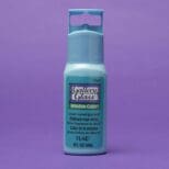 A bottle of Gallery Glass Paint Most Popular Kit in turquoise, displayed against a purple background.