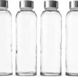 Four glass bottles with silver lids are lined up.