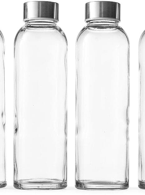 Four glass bottles with silver lids are lined up.