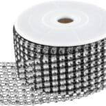 A roll of black and silver ribbon with many rows of beads.