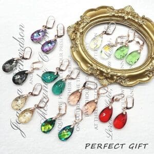 Crystal teardrop earrings displayed around an ornate gold frame with "perfect gift" text on paper.