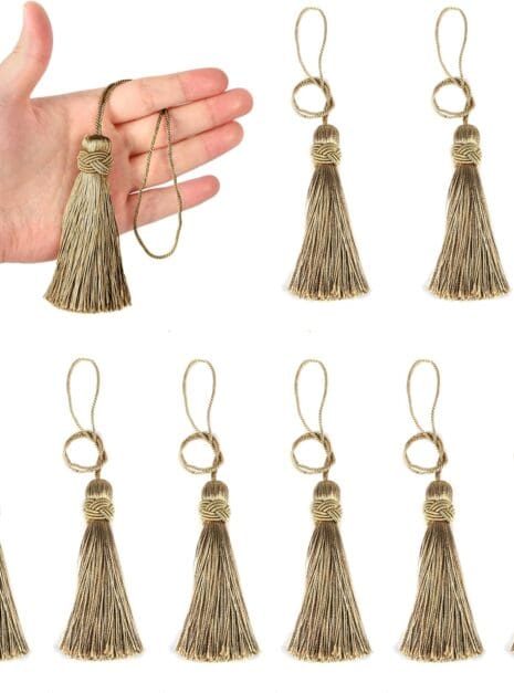 A hand holding a dozen tassels in front of each other.