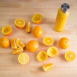 A table with oranges and juice on it