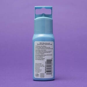 A blue spray bottle labeled "Gallery Glass Paint Best Seller" against a purple background.
