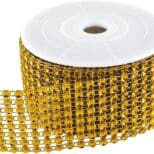 A roll of gold ribbon with black and white diamond pattern.