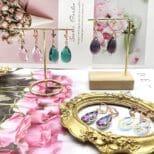 A table with several different types of earrings.