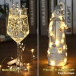 A wine glass and bottle with lights on it