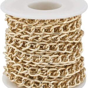 A spool wrapped with multiple layers of gold chain links, isolated on a white background.