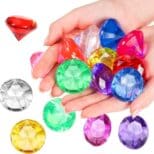 A hand holding some different colored gems