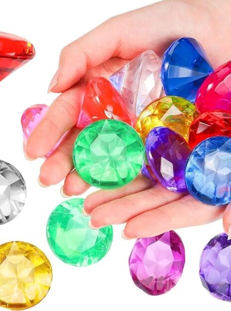 A hand holding some different colored gems