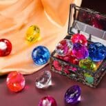 A box of colorful jewels sitting on top of a table.