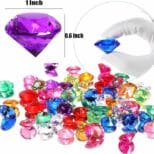 A bunch of different colored plastic jewels sitting on top of each other.