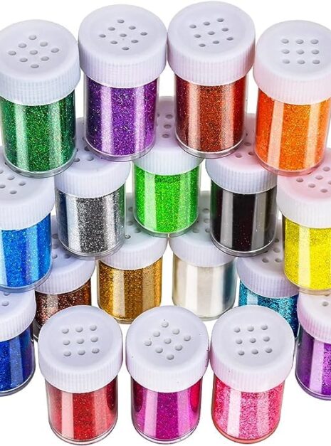 A group of different colored jars with lids.