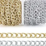 Gold and silver chain links displayed in rolls and strands.