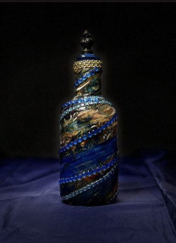 A bottle with blue and gold designs on it